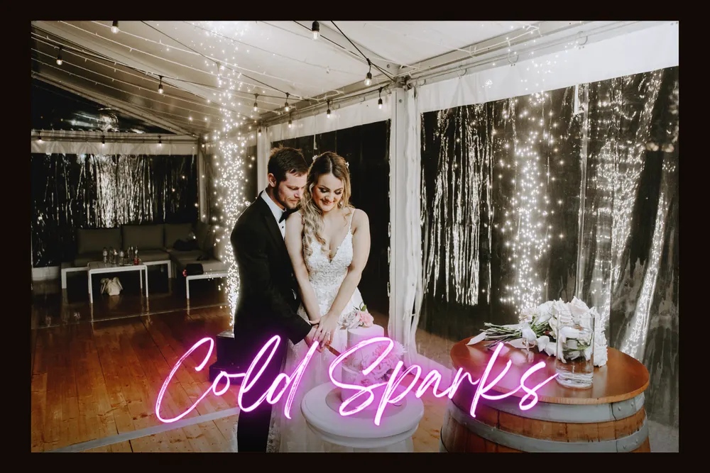 Couple sharing a first dance framed by cold spark fountains