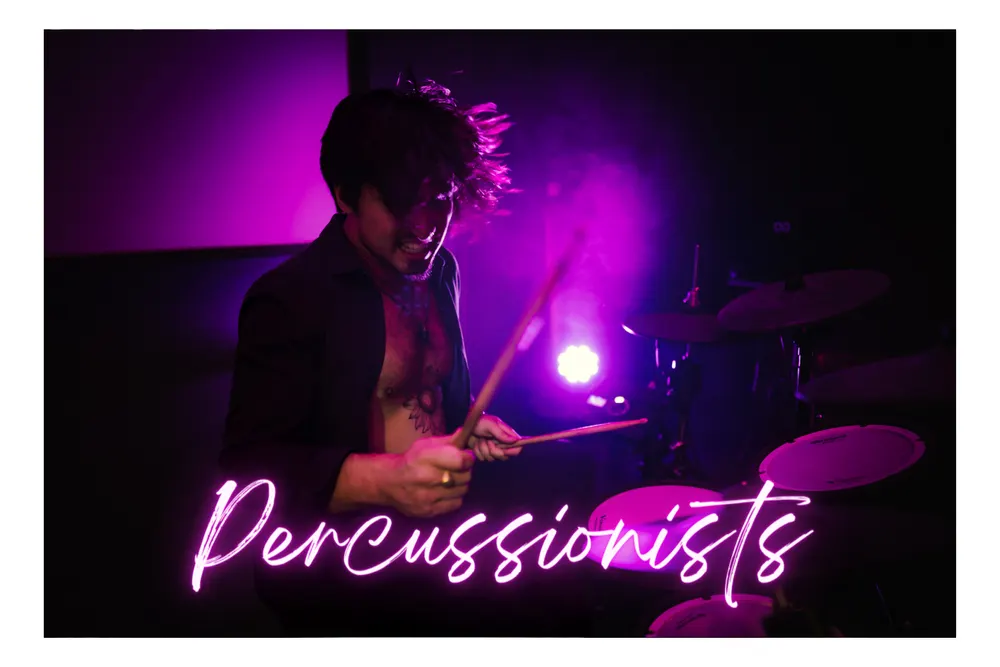 Percussionist performing under purple lighting