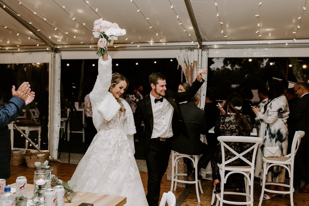 Bride and groom dancing surrounded by guests